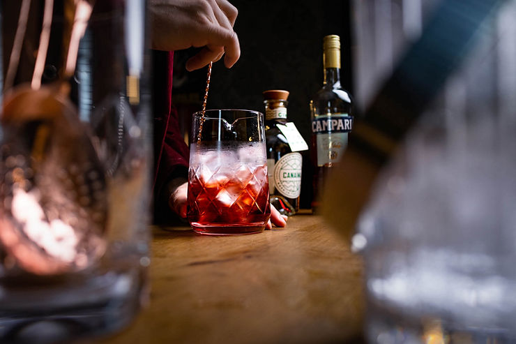 man stirring cocktail