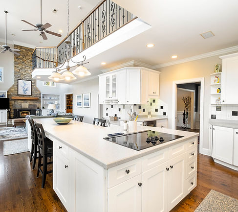 Beautiful white kitchen overlooking living room inside Lake Norman waterfront home