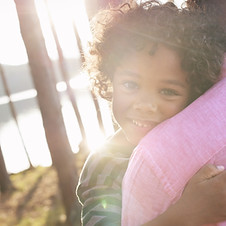 Man Carrying Child in Arms