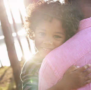 Man Carrying Child in Arms