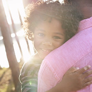 Man Carrying Child in Arms