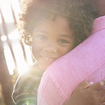 Man Carrying Child in Arms