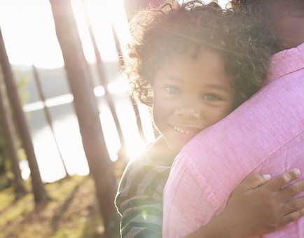 Man Carrying Child in Arms