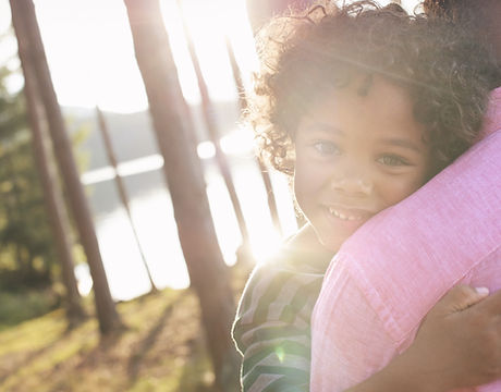 Man Carrying Child in Arms