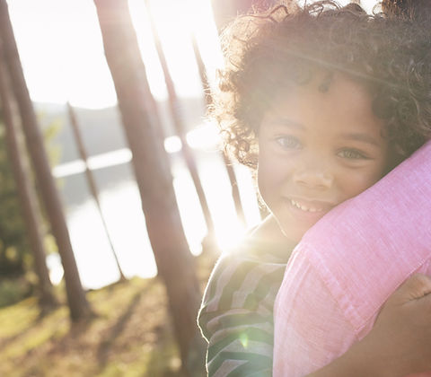 Man Carrying Child in Arms