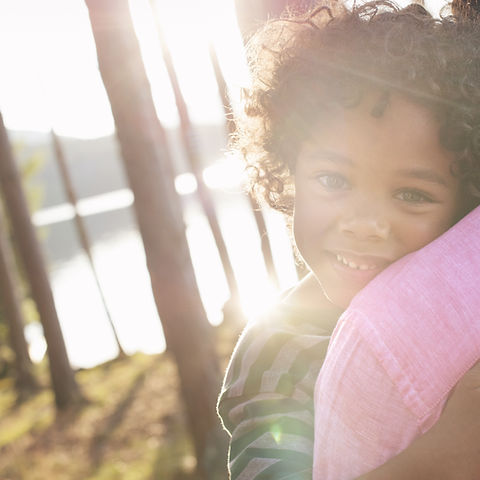 Man Carrying Child in Arms