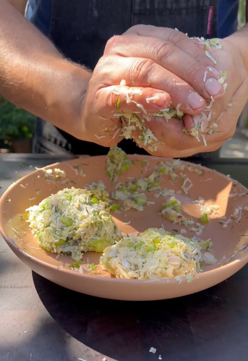 the crab cakes being formed into patties by hand
