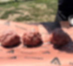 salting balls of ground beef to make smash burgers