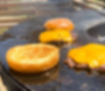 cheese melting on the burgers on the grill and the toasted bun
