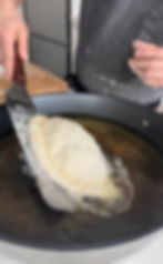 the panzerotto going into hot oil to fry