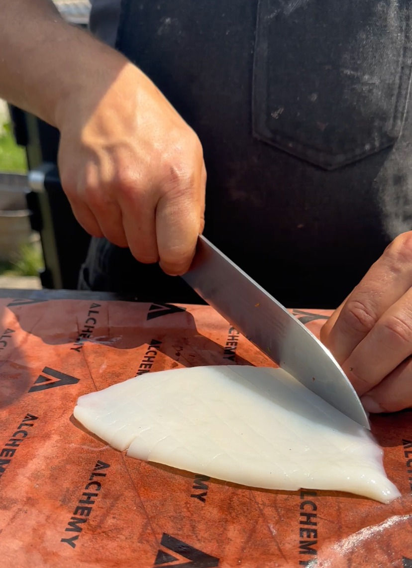 scoring the calamari with a diamond pattern