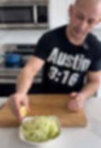 chef Matt Basile squeezing fresh lemon juice over the sliced apples