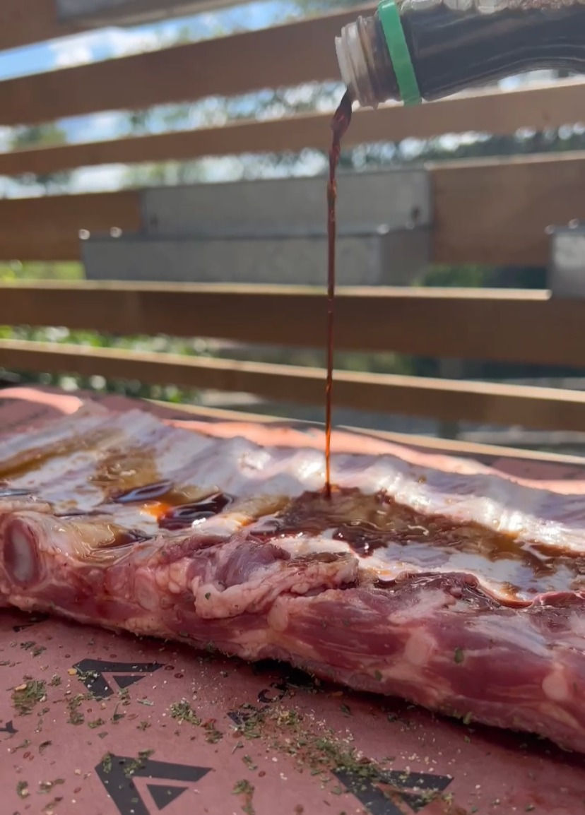 soy sauce being poured onto the pork side ribs