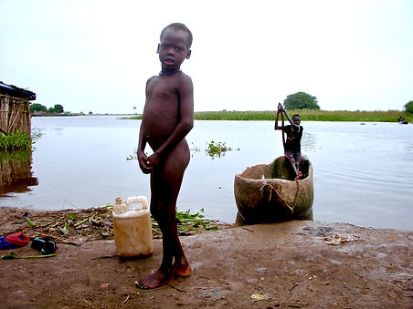 Tom Kilian of Mercy Partners takes photo of youth coming home from fishing in the Nile River, South Sudan, Ethiopia