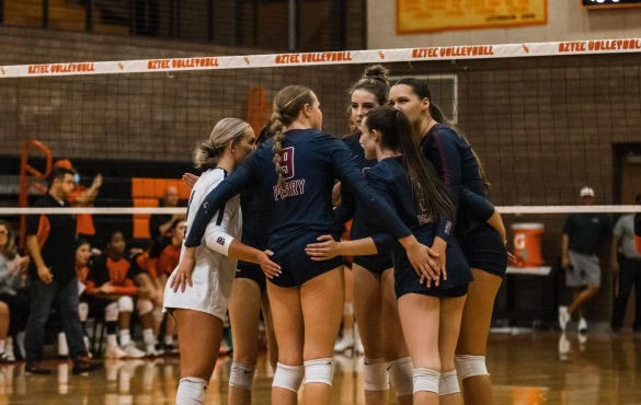 Volleyball players in a huddle