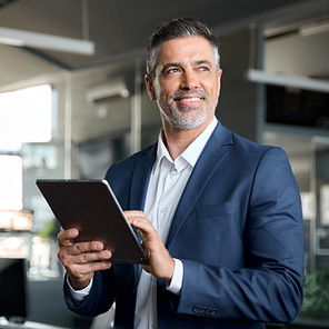 An executive holding a tablet.
