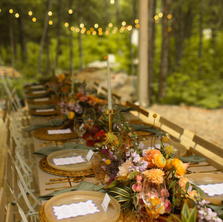 Wedding table and decorations: colorfull flowers, fruits and candles