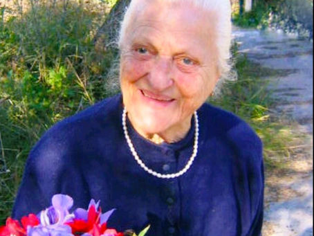 Maria Panagiotopoulou during one of her final visits to the family olive groves in Greece, smiling among the olive trees that inspired the PJ Kabos legacy.