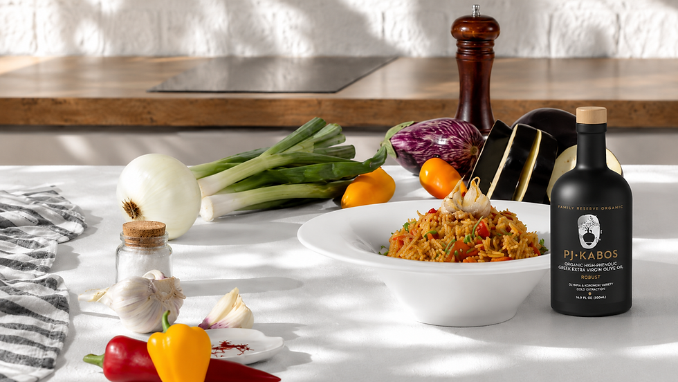 Chicken pilaf with vegetables served beside PJ Kabos high-phenolic olive oil and fresh ingredients.
