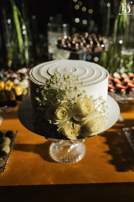 Bolo de casamento naked cake com rosas brancas e mosquitinho em cima de aparador dourado