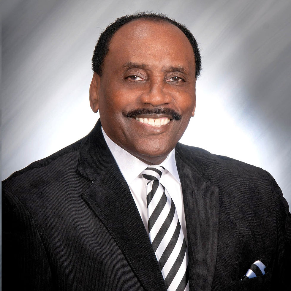 Smiling man in a suit with a striped tie. Gray gradient background. Professional, confident mood.