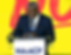 Dr. Derrick L. Foward in a navy blue suit and tie speaks at a podium with an NAACP sign, against a vibrant yellow and red backdrop at a national convention.