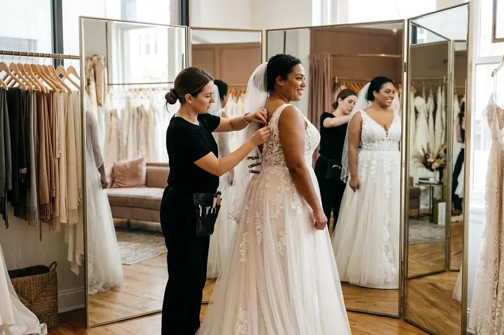Bridal consultant fitting an alteration-friendly sample gown on a bride.