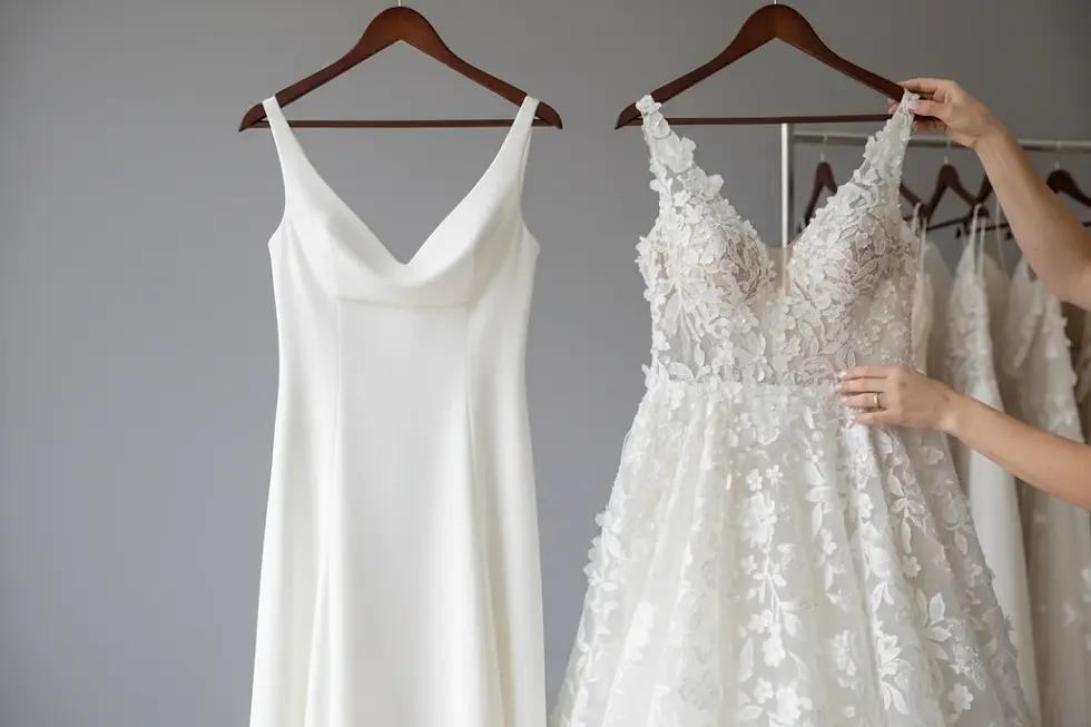 Core and statement bridal gowns hanging side-by-side to display effective wedding dress assortment planning.
