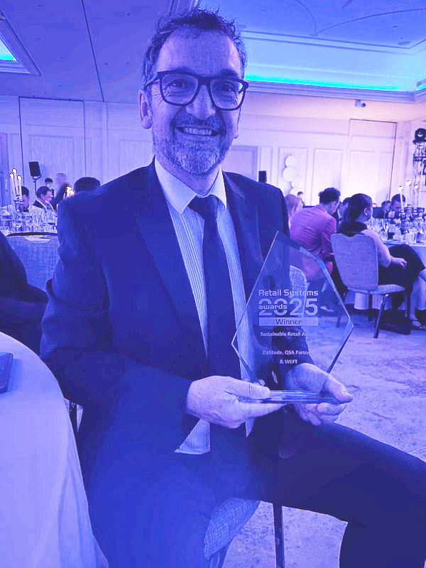 Gavin Wilkinson holding the Retail Systems 2025 Winner Award
