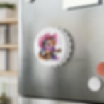 Cute cat magnet in pink cowboy hat plays guitar on a stainless steel fridge, with music notes in a cozy kitchen.