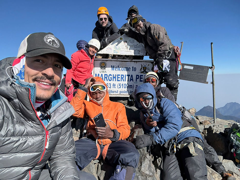 All smiles on the Roof of Uganda - the summit of Margherita Peak (5,109m) on Mt Stanley.