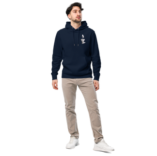 Person wearing a navy blue hoodie with a graphic on the left chest, paired with beige pants, standing against a plain background