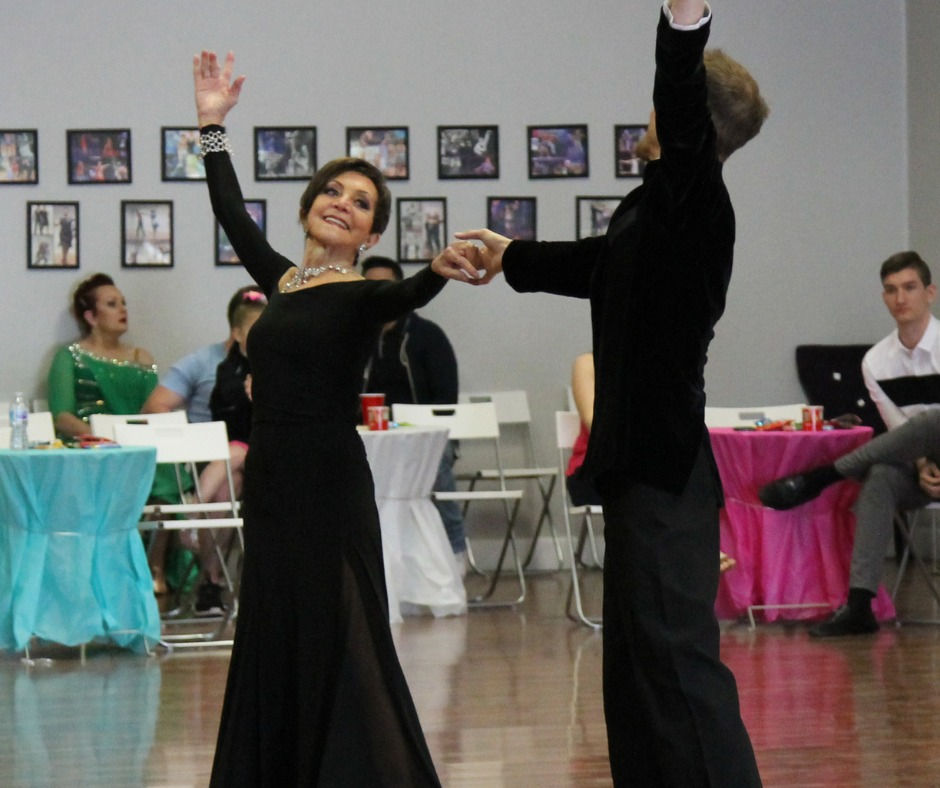 Solo dancer confidently enjoying their performance after taking ballroom dance lessons without her spouse.