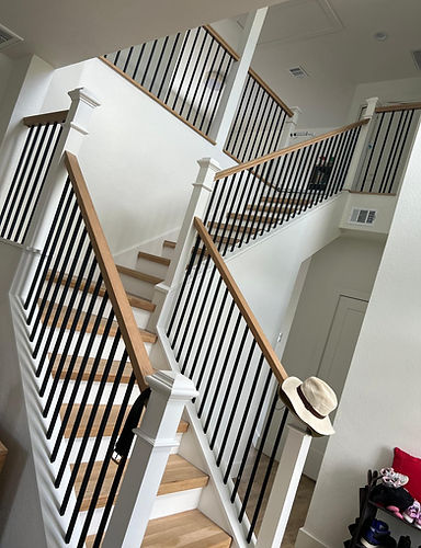 Handcrafted staircase with intricate railing design and hardwood flooring