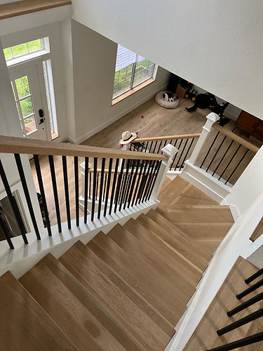 Handcrafted staircase with intricate railing design and hardwood flooring