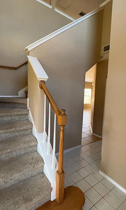Handcrafted staircase with intricate railing design and hardwood flooring