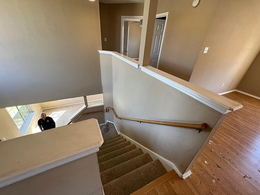 Handcrafted staircase with intricate railing design and hardwood flooring