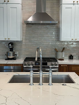 Modern, open-concept kitchen renovation with sleek countertops and custom cabinetry
