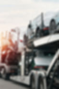 SUVs loaded on hauler truck for delivery.jpg