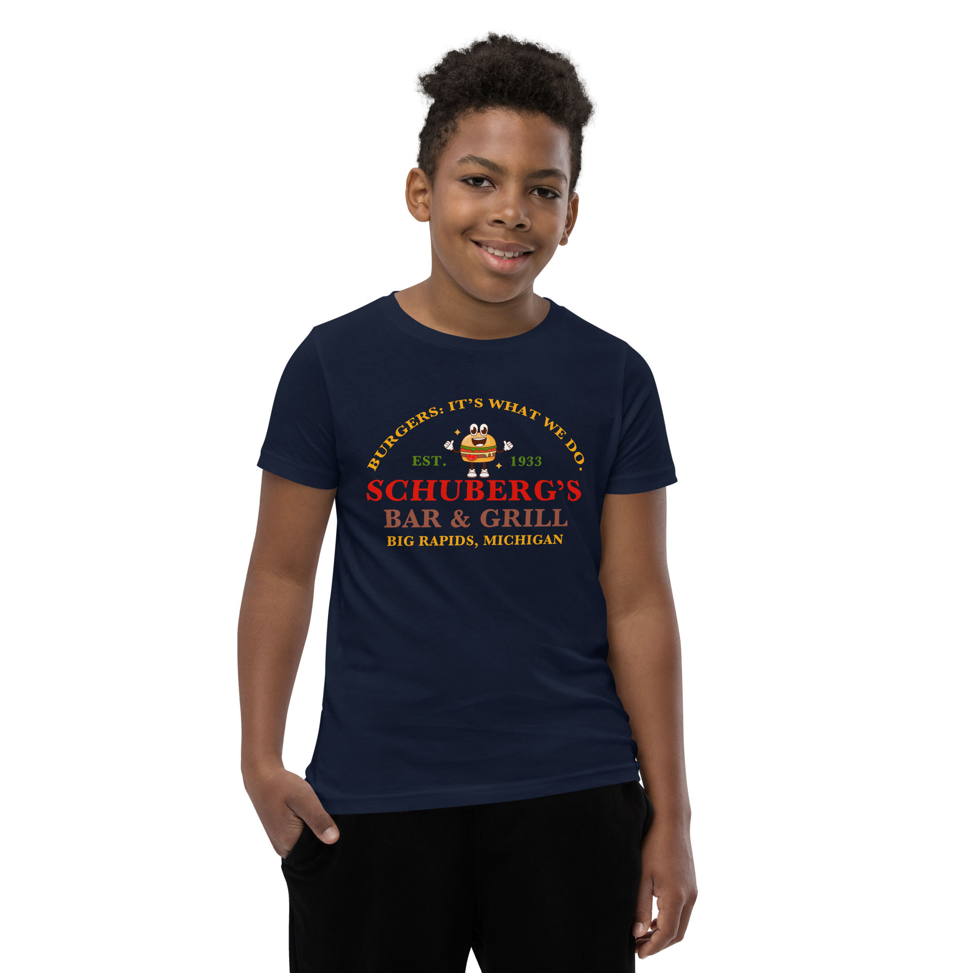 Front of Kids Navy Blue t-shirt with cartoon burger and yellow text "Burger's It's What We Do." on top and red and brown "Schuberg's Bar & Grill" text in the middle with yellow "Big Rapids, Michigan" text on the bottom.