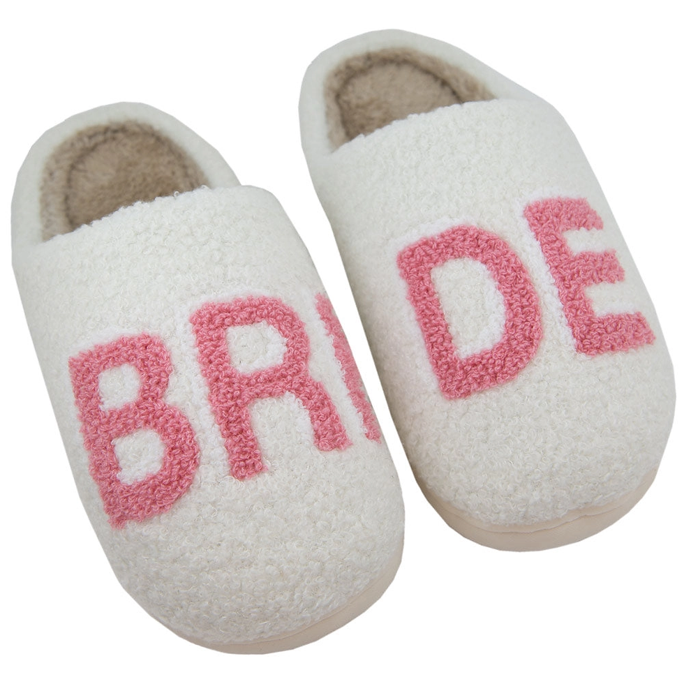 BRIDE white fuzzy slippers with pink text.