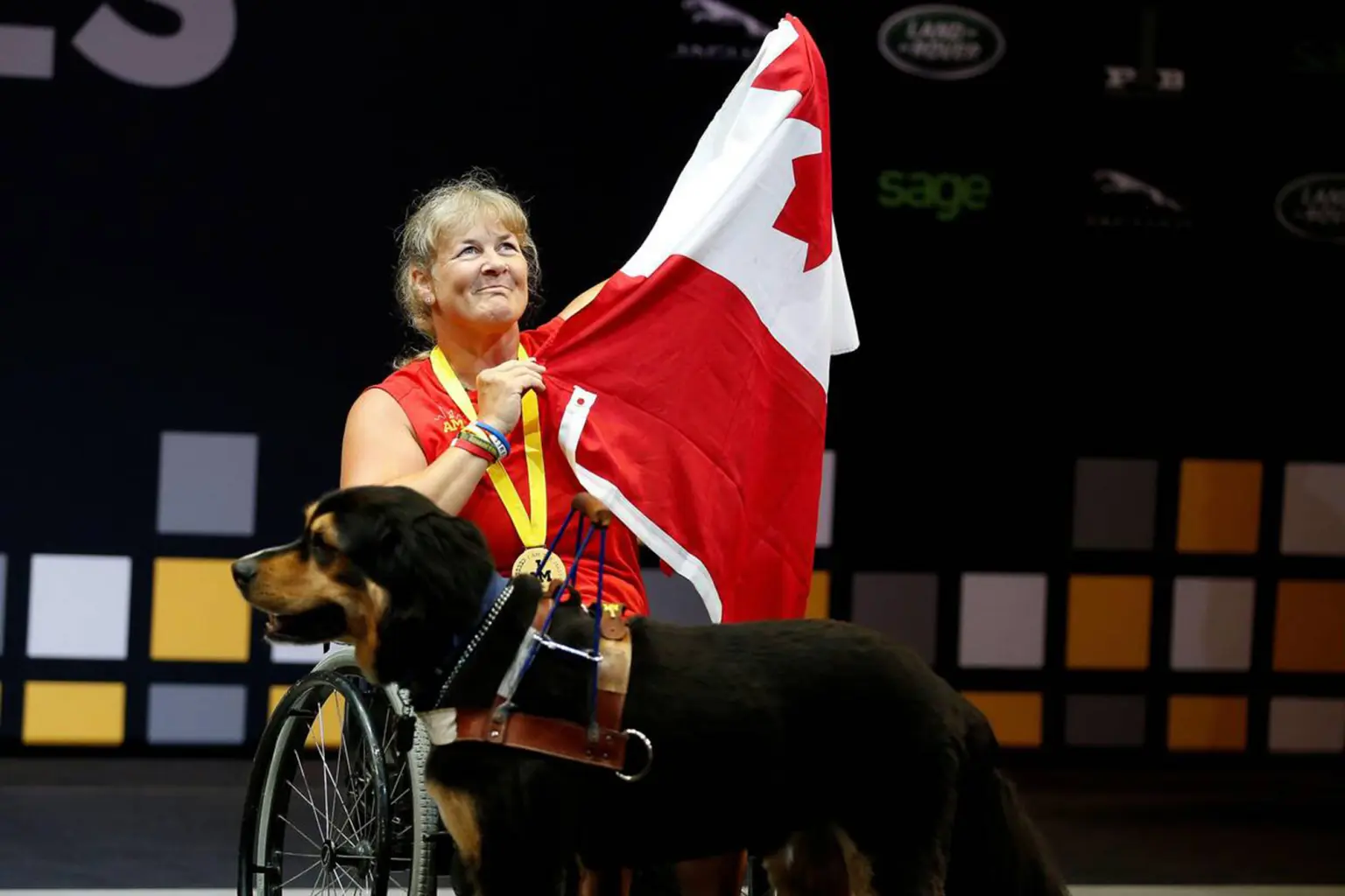 Christine Gauthier holding Canadian flag with dog
