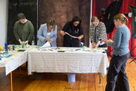 Louise Brook leading an art workshop in a corporate team building setting.