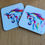 Thumbnail: Set of two unicorn coasters, angled view. Rainbow unicorn against a white background.