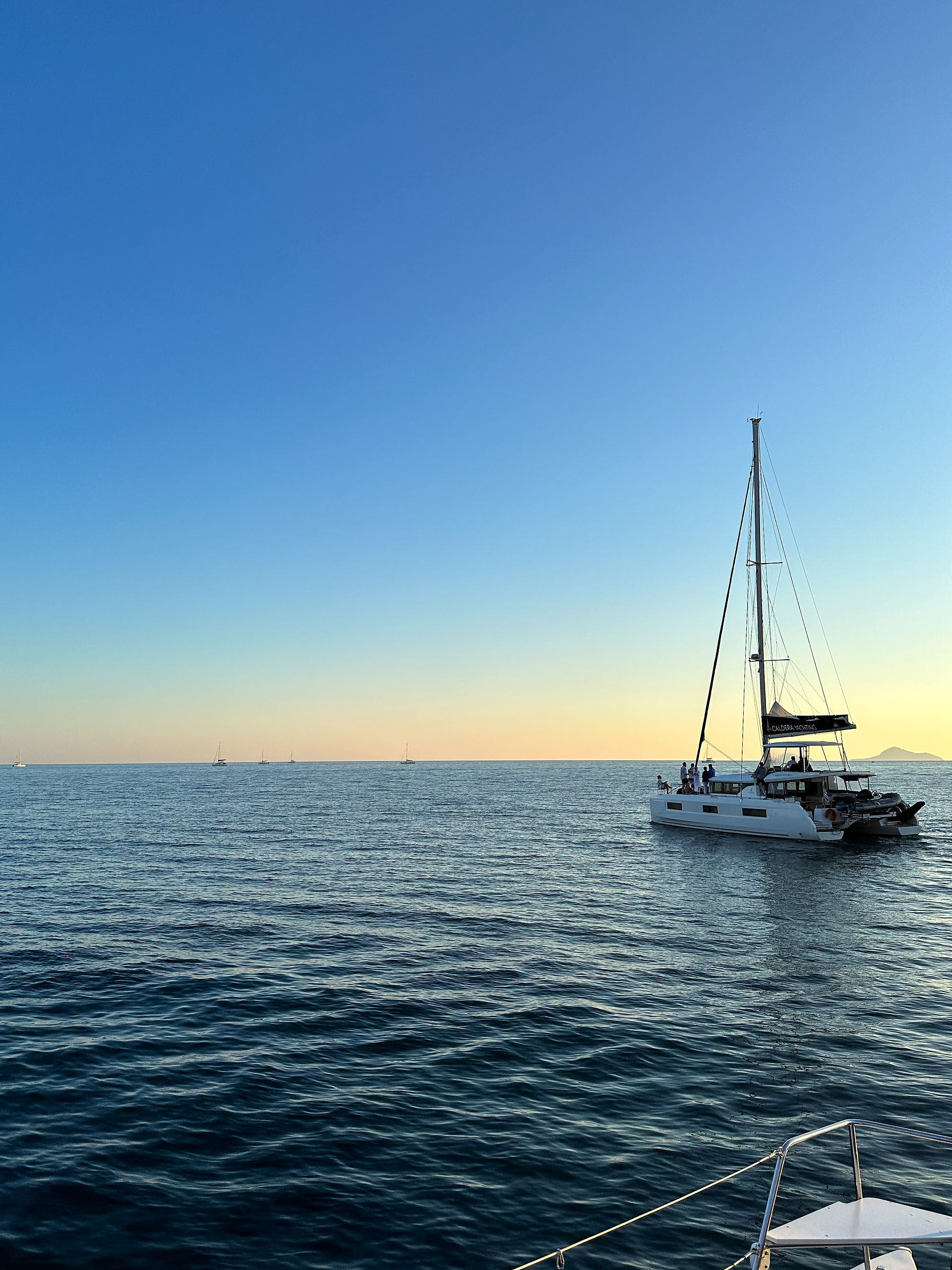 Luxury Yacht sailing in the Aegean ocean at sunset