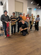 Nine smiling Bay Street Brass musicians just after rehearsing. 