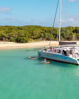 Luxury catamaran sailing tour in San Juan, Puerto Rico, featuring premium deck seating, snorkeling over coral reefs, and views of the Caribbean coast.
