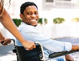 african man in wheelchair engaging in community