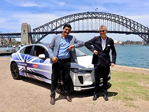 Two men standing by a GREAT branded Jaguar