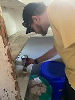 Ben works on a building project while volunteering with Kulea Villages in Tanzania. 